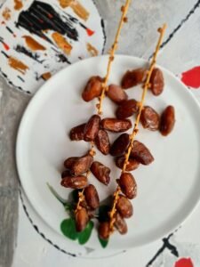 Two sprigs of fresh dates beautifully arranged on a plate, perfect for Ramadan iftar.